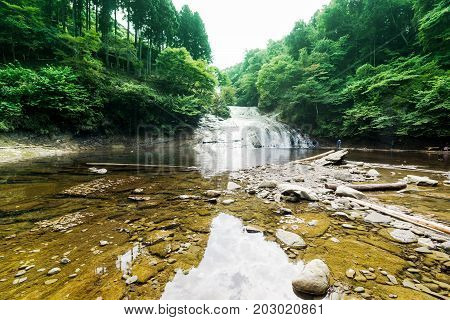Japan travel concept - beautiful yoro keikoku valley waterfall under sun glow and morning blue sky in Chiba Prefecture Japan