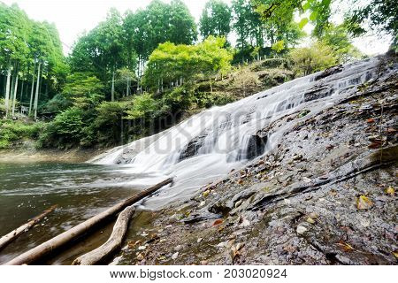 Japan travel concept - beautiful yoro keikoku valley waterfall under sun glow and morning blue sky in Chiba Prefecture Japan