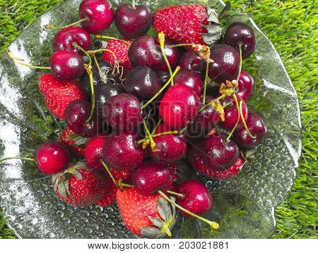 Fresh ripe sweet cherries and strawberry. Summer food conce