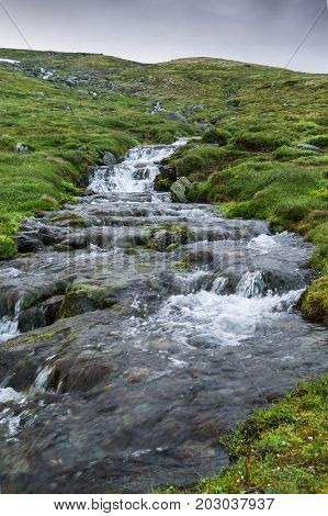 Waterfall in the mountains along the National tourist route Aurlandstjellet. Flotane. Western Norway