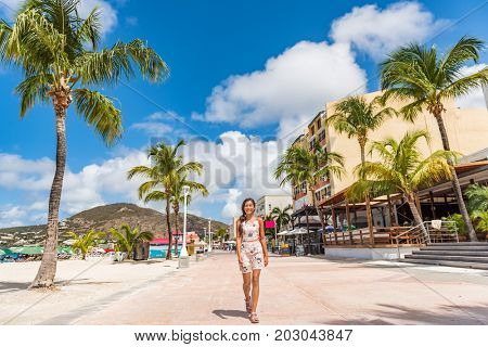 St Maarten Woman tourist walking in shopping streets of Philipsburg, St Maarten, popular port of call for cruise ship travel destination. Caribbean tropical getaway.