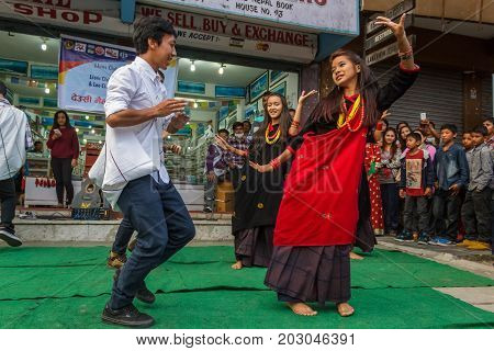 POKHARA NEPAL - 11/9/2015: A group of young Nepalese dancers perform in traditional clothes during the Tihar festival in Pokhara Nepal.