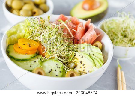 Hawaiian fish poke with rice avocado and sprouts.