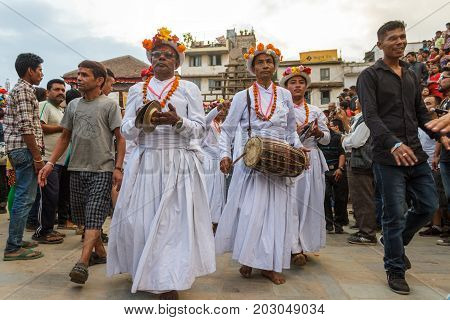 KATHMANDU NEPAL - 9/26/2015: Musical performers walk through the crowd during the Indra Jatra festival at Durbar Square in Kathmandu Nepal.
