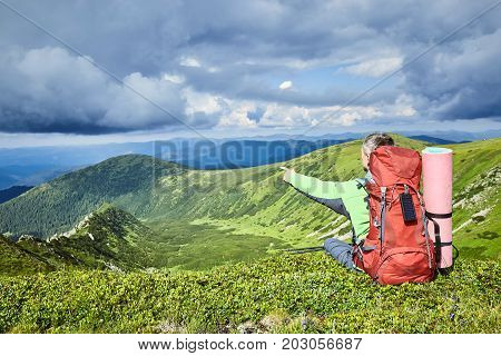 Hiking in the mountains with a backpack in the summer.