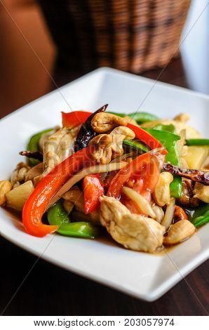 Stir-Fried Cashew Chicken, Slices of chicken breast stir-fried with cashew nuts, peapods, pineapple, onions, tomato ,and bell peppers