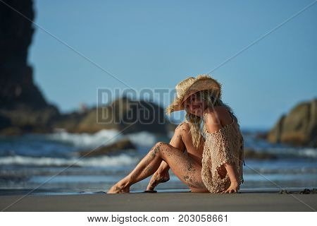 young woman relaxing on the beach in summer day