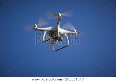 The drone in the sky. Close up of quadrocopter outdoors.