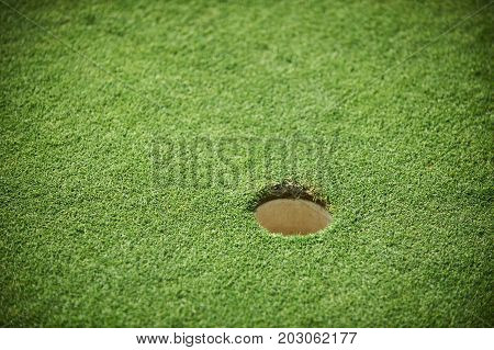 golf hole on a green field close up