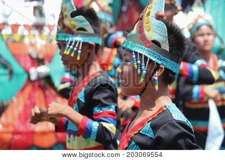 DAVAO CITY, PHILIPPINES--AUGUST 2014: Kids in colorful costumes at the Kadayawan streetdancing parade 
Kadayawan is celebrated August each year to give thanks for life and an abundant harvest.