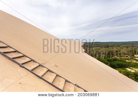 Ladder to the Dune of Pilat - the tallest sand dune in Europe. The dune is located in La Teste-de-Buch in the Arcachon Bay area France