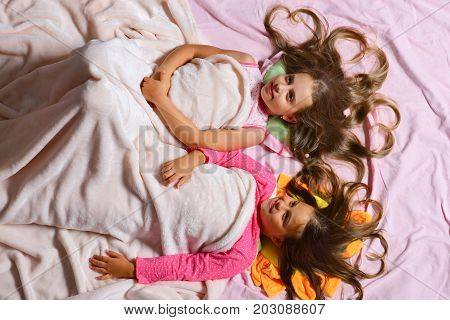 Kids With Happy Faces And Hearts In Hair In Bed