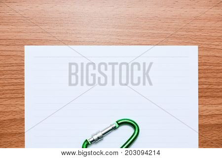 White line paper with sport equipments on brown wooden table top view
