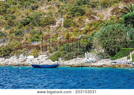 Sea shore with little boat in Maslinica Solta island Croatia. Summer vacation destination.