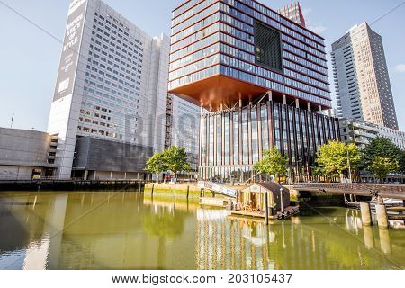 ROTTERDAM, NETHERLANDS - August 06, 2017: View on the Wijn port with Red Apple building and house on the water in Rotterdam