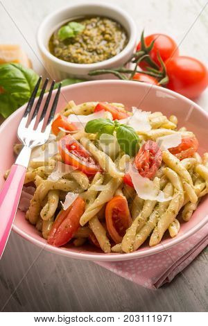 pasta with pesto  tomato e parmesan cheese flake, selective focus