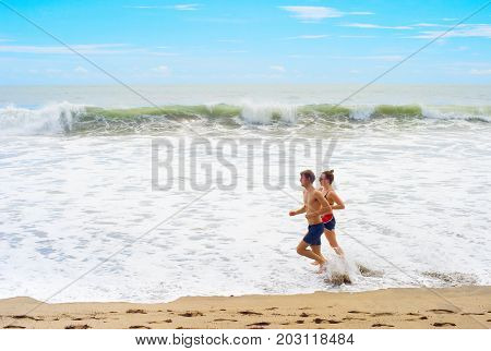 Couple Jogging On Th Beach