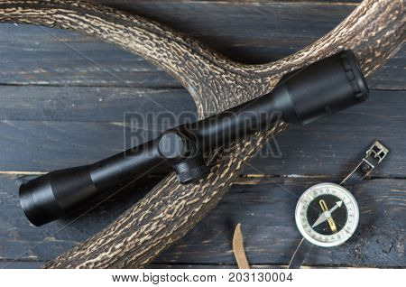 Black Optical Sight For Hunting And A Tourist Compass.