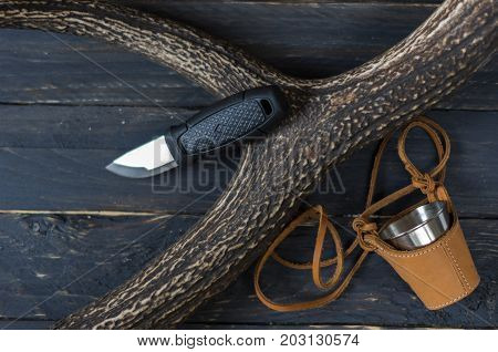 Knife And Mug On A Black Background.