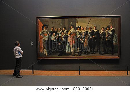 AMSTERDAM, THE NETHERLANDS - MAY 4, 2016: Visitors and The Meagre Company (1637) by Frans Hals at the famous Rijksmuseum in Amsterdam, Netherlands.