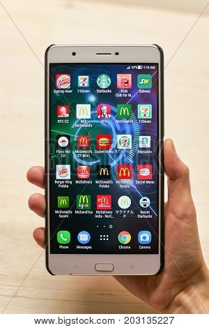 KALININGRAD, RUSSIA - CIRCA SEPTEMBER, 2017: a set of apps on Asus Zenfone 3 Ultra smartphone in woman hand.
