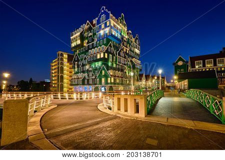 ZAANDAM, NETHERLANDS - MAY 8, 2017: Inntel Hotel in Zaandam illuminated at night. Design of 12-storey tall building opened in 2009 is the result of stacking a series of traditional Dutch houses