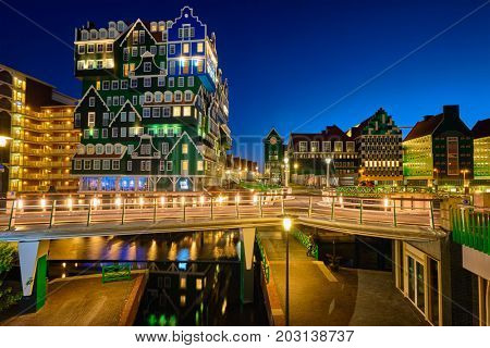 ZAANDAM, NETHERLANDS - MAY 8, 2017: Inntel Hotel in Zaandam illuminated at night. Design of 12-storey tall building opened in 2009 is the result of stacking a series of traditional Dutch houses