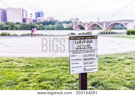 Washington Dc, Usa - August 4, 2017: Rock Creek Park Labyrinth Sign By Potomac River, Key Bridge And