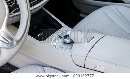 Media and navigation control buttons of a Modern car. Car interior details. White leather interior of the luxury modern car. Modern car interior