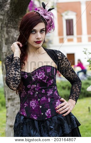 CAGLIARI, ITALY - JUNE 1, 2014: Sunday at the Great Jatte Public Gardens - portrait of a beautiful woman wearing a Victorian style costume - Sardinia