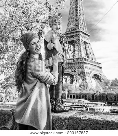 Mother And Child Travelers Handwaving On Embankment In Paris