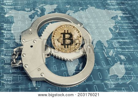 Cryptocurrency, blockchain concept. World are in hostages by Bit coin. Bitcoin in handcuffs over the world map.