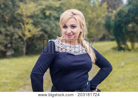 Beautiful girl model in a park, posing for photo camera