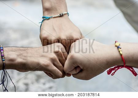 Three Hands Wearing Rakhi.
