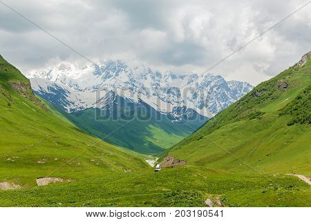landscape summer and snowy mountain peaks near the village of Mestia, Georgia