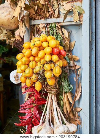 Piennolo tomatoes bunch in a greengrocer stall. Pomodorino del Piennolo del Vesuvio. Neapolitan organic tomato.