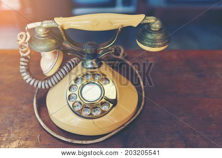 Classic old rotary dial telephone on wood table