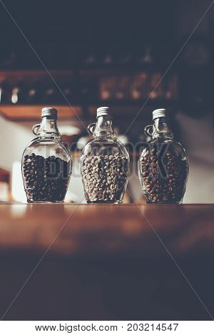 Green beans and Coffee beans inside the clear bottle Focus only subject blur backgroundCopy Space for Text Layout Chiangmai Thailand