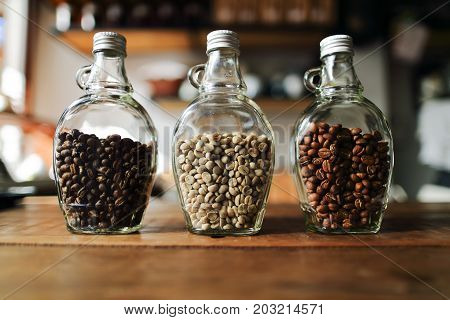 Green beans and Coffee beans inside the clear bottle Focus only subject blur backgroundCopy Space for Text Layout Chiangmai Thailand