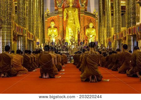 CHIANG MAI THAILAND - 1/18/2016: Monks praying at Wat Chedi Luang temple in Chiang Mai Thailand.