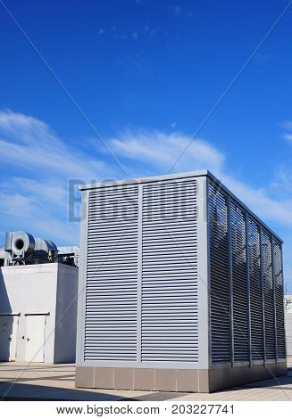 Industrial air conditioning and ventilation systems on the street against clody sky. Ventilation system of factory.