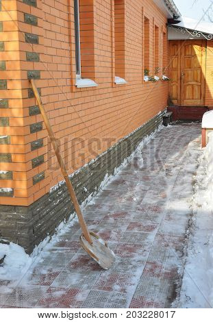 Clearing road after a big snowstorm with snow shovel.