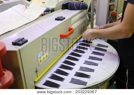 MOSCOW - FEB 21, 2017: Woman hands put details for shoes in Ralf Ringer shoes factory. For the production of shoes Ralph Ringer use only genuine leather