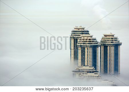 MOSCOW, RUSSIA - SEP 26, 2014: Residential complex Sparrow Hills (Vorobyovy Gory) in morning fog. Complex located on the right bank of the Moskva River.