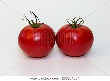 Tasty fresh red tomatoes isolated on white background.