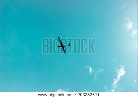 The glider gliding in the blue sky, glider flight