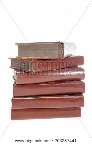 Pile of untitled old leather bound books. Stack of antique literature for World Literacy day. Isolated against white background.