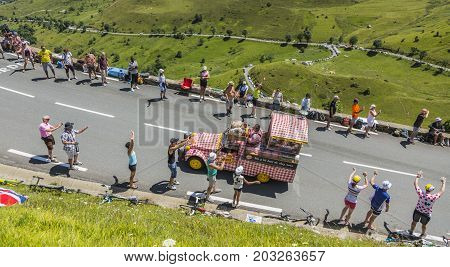Col de PeyresourdeFrance- July 23 2014: Cochonou vehicle passing in the Publicity Caravn on the road to Col de Peyresourde in Pyrenees Mountains during the stage 17 of Le Tour de France 2014.Cochonou is an important French brand of short dry sausages.