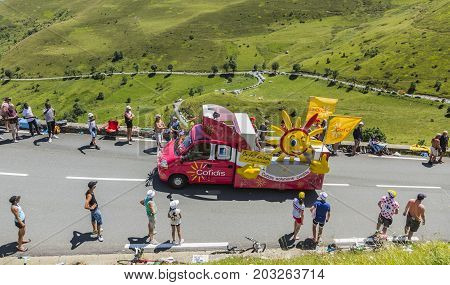 Col de PeyresourdeFrance- July 23 2014: Cofidis vehicle passing in the Publicity Caravn on the road to Col de Peyresourde in Pyrenees Mountains during the stage 17 of Le Tour de France 2014.