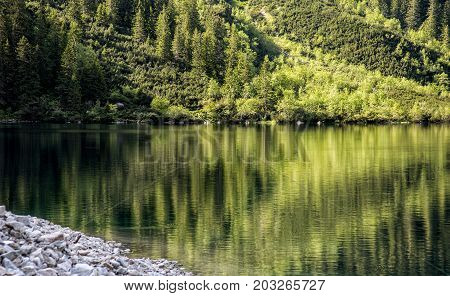 Morskie Oko lake with rocks under water at Tatra Mountains, Poland.